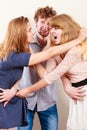 Aggressive mad women fighting over man. Royalty Free Stock Photo