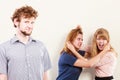 Aggressive mad women fighting over man. Royalty Free Stock Photo