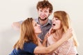 Aggressive mad women fighting over man. Royalty Free Stock Photo