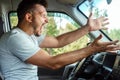 Aggressive Man, the driver of the car is outraged at the wheel during the trip. Emergency, accident, violation of rights, dispute Royalty Free Stock Photo