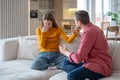 Aggressive stressed tyrant man husband shouting grabs wife woman by arm. Difficult abusive relations Royalty Free Stock Photo