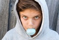 Aggressive teenage boy blowing bubble gum Royalty Free Stock Photo