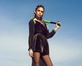 Aggressive teenager. Young woman with stylish long braids, brunette hair, makeup, in fashionable, black dress posing Royalty Free Stock Photo