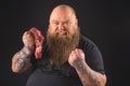Aggressive thick man holding meat