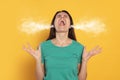 Aggressive woman with steam coming out of her ears on background Royalty Free Stock Photo