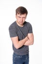 Aggressive young man with light beard, arms folded, isolated on Royalty Free Stock Photo