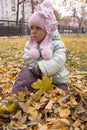 Aggrieved girl sitting on leaves Royalty Free Stock Photo