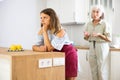 Aggrieved woman having quarrel with her elderly mother