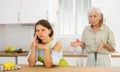 Aggrieved woman having quarrel with her elderly mother