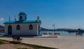 Aghios Nikolaos Orthodox Church and Mediterranean Fishing Boats on Water in Euboea - Nea Artaki, Greece Royalty Free Stock Photo