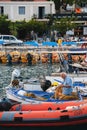 Agia Efimia, Cephalonia island, Greece - July, 12 2019: An old Greek fisherman sitting in a boad and preparing a fishing