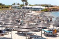 AGIA NAPA, CYPRUS - April 7, 2018: Sunbeds and rattan umbrellas on famous blue flagged Nissi beach Royalty Free Stock Photo