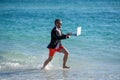 agile beachside business. Beach productivity for the director businessman. Businessman director running at the beach Royalty Free Stock Photo