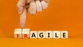 Agile or fragile symbol. Concept words Agile and Fragile on wooden cubes. Beautiful orange table orange background. Businessman