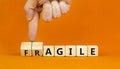 Agile or fragile symbol. Concept words Agile and Fragile on wooden cubes. Beautiful orange table orange background. Businessman