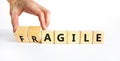 Agile or fragile symbol. Concept words Agile and Fragile on wooden cubes. Beautiful white table white background. Businessman hand