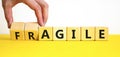 Agile or fragile symbol. Concept words Agile and Fragile on wooden cubes. Beautiful yellow table white background. Businessman