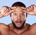 Aging, anxiety and black man portrait in studio for skin, check and beauty routine on blue background. Skincare face