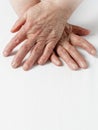 Aging hands of an old 80 year old woman with age spots,  deep wrinkles on the skin and flaky nails Royalty Free Stock Photo