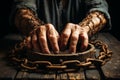 Aging Hands in Rusty Chains Resting on Weathered Wooden Table Under Soft Light Royalty Free Stock Photo