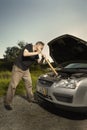 Older man alone on route checking unfunctional engine in late summer light Royalty Free Stock Photo
