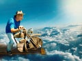 An aging man on a wooden motorcycle takes off from the runway into the sky towards the sun Royalty Free Stock Photo