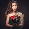 Aging, skin care concept. Half old half young woman with bouquet of red roses.