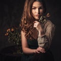 Aging, skin care concept. Half old half young woman with faded rose bouquet. Royalty Free Stock Photo