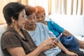 Aging society concept with Asian elderly senior adult women sisters using mobile digital smart phone application