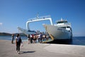 Agiokampos, Evia island, Greece - August 15, 2023: People on summer vacation entering ferryboat at Agiokampos, Evia ilsand.