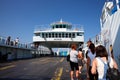 Agiokampos, Evia island, Greece - August 15, 2023: People on summer vacation entering ferryboat at Agiokampos, Evia ilsand.