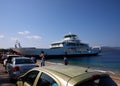Agiokampos, Evia island, Greece - August 15, 2023: People and vehicles entering ferryboat at Agiokampos, Evia ilsand. Concept of