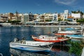 Agios Nikolaos,Crete - October 6,2019.View of small lagoon Lake Voulismeni and port with boats surrounded by several bars and