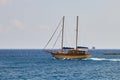 Agios Nikolaos, Greece, August 17, 2013: Beautiful two-masted private schooner swims past the island Royalty Free Stock Photo