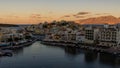 AGIOS NIKOLAOS,  GREECE - SEPTEMBER 24 2021: Panoramic view of sunset over the lake at the town of Agios Nikolaos in the Lasithi Royalty Free Stock Photo