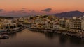 AGIOS NIKOLAOS,  GREECE - SEPTEMBER 24 2021: Panoramic view of sunset over the lake at the town of Agios Nikolaos in the Lasithi Royalty Free Stock Photo