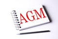 AGM word on notebook on white background Royalty Free Stock Photo