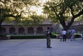 Agra, India - April 10, 2014: An army personnel allocated as security guard in world heritage site and tourists taking pictures in
