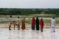 Agra, India - August 19, 2009: group of Indians who admire the panorama behind the Taj Mahal in Agra in India