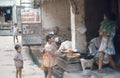 1975. India. Children buying sweet cakes. Agra.