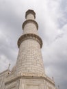 AGRA, INDIA - MARCH, 26, 2019: close up low angle shot of a marble minaret of the taj mahal Royalty Free Stock Photo