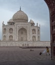 AGRA, INDIA - MARCH, 26, 2019 early morning view of the taj mahal, framed by an arch, with a mischievous monkey Royalty Free Stock Photo