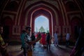 Agra, India - September 20, 2017: Crowd of people walking through a huge door with the Taj Mahal in the horizont , is an