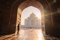 tourist standing in front entrance gate of Taj Mahal indian palace. Islam architecture. Door to the mosque Royalty Free Stock Photo