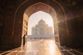 tourist standing in front entrance gate of Taj Mahal indian palace. Islam architecture. Door to the mosque Royalty Free Stock Photo