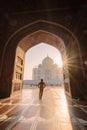 tourist standing in front entrance gate of Taj Mahal indian palace. Islam architecture. Door to the mosque Royalty Free Stock Photo