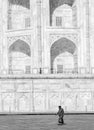 A woman walks outside the Taj Mahal
