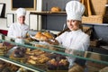 Agreeable woman and young girl reccomending pastry Royalty Free Stock Photo