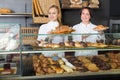 Agreeable woman and young girl suggesting pastry