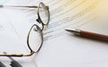 Agreement with pen and glasses. Selective focus. Business work office career concept Royalty Free Stock Photo